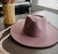 Made from colorful purple felt and formed into a chic fedora shape, this wide brim hat is the felted women's hat perfect for winter styling. Pair the cute hat accessory with winterwear favorites or trendy bohemian fashions for a pop of color. size adjustable 90% polyester, 5% cotton, 5% wool height: 4 ½” circumference: 24” brim width: 3 ½” Purple Wide Brim Hat, Wide Brimmed Hats, Cute Hats, Wide Brimmed, Ladies Boutique, Winter Wear, Bohemian Style, Hats For Women, Winter Fashion