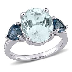 Draw immediate attention with this fascinating Ice Aquamarine, London Blue Topaz and Diamond-Accent Three-Stone Ring crafted in glittering sterling silver. This ring features an oval-cut, prong-set ice aquamarine gemstone (12 x 10mm) at the center with a heart-cut, prong-set London blue topaz gemstone on each side. This ring is further accentuated by 12 round-cut, pave-set twinkling diamonds (G-H, I2-I3) resting along the band. Perfect for any occasion, this gemstone and diamond ring is a fabulo Topaz Birthstone Ring, Aquamarine Birthstone Ring, Heart Wedding Rings, Fashion Rings Silver, Solitaire Earrings, Blue Topaz Gemstone, Blue Topaz Stone, Aquamarine Ring, Aquamarine Gemstone