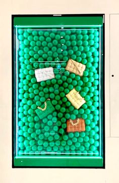 there is a green display case with different items on it