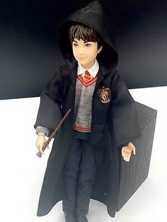 a harry potter doll with a wand and hat