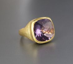 ♦♦ Beautiful handcrafted ring ◘Stone Information: Genuine Amethyst - Color: Purple Cut: Briolette Cushion Size: 15 mm ◘ Metal: 925 Sterling Silver ◘ Band: 4.5 mm textured ◘ Setting: Open back bezel setting ◘ Finish: High polish (shiny) ◘ Nickel free ◘ Anti tarnish ◘ Vermeil Gold ◘ Handmade band: 14 gauge solid sterling wire This ring is adorably rustic, easy to wear, & stackable! ◘Please Note - The Ring in the Picture can be available or Sold out. Every Ring is Made of a Unique Gemstone. The Gold Amethyst Ring With Large Stone As Gift, Formal Amethyst Rings With Large Stone, Elegant Amethyst Gemstone Signet Ring, Amethyst Ring With Large Stone For Anniversary, Amethyst Gemstone Signet Ring As Gift, Elegant Amethyst Rings With Large Stone, Amethyst Gemstone Signet Ring For Gifts, Elegant Amethyst Ring With Large Stone, Anniversary Rings With Large Amethyst Stone