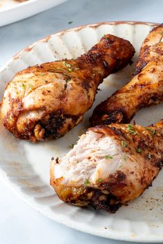 three pieces of chicken on a white plate