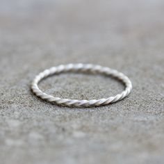 a white rope ring sitting on top of a cement floor