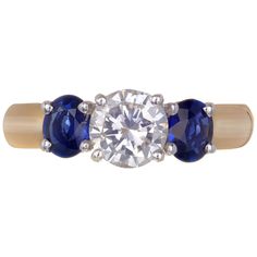 an engagement ring with three stone sapphires