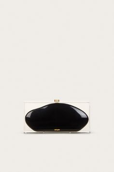 Taking a nod from 60’s mod glamour, the Annika Clutch is designed as a black curved clutch inside of a translucent box. The clear acrylic outside offers a very retro-inspired feel, and the black abstract-shaped middle casing creates a stark contrast. From weekend travels, to parties and galas — she’s sure to be an artful addition to any outing. Modern Black Clutch For Formal Occasions, Modern Black Formal Clutch, Modern Black Clutch For Evening, Modern Black Clutch For Events, Black Rectangular Clutch For Parties, Black Rectangular Case Clutch For Party, Sleek Black Clutch For Party, Sleek Black Evening Clutch, Sleek Black Party Clutch