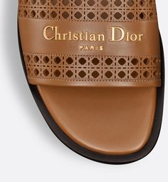 The D-Lane slide is an emblematic style with a timeless look. The camel openwork Microcannage calfskin upper is adorned with a gold-finish metal Christian Dior Paris signature, adding an instantly recognizable touch. The padded leather insole offers ultimate comfort while the streamlined design makes it easy to slip on for a laid-back look.. 42 Christian Dior Paris, Dior Paris, Streamlined Design, Design Minimalista, Mule, Gold Finish, Christian Dior, Calf Skin, Camel