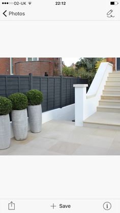 three large planters sitting on the side of a building