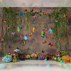 there are many butterflies hanging from the ceiling and decorations on the wall behind them,