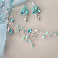 Turquoise hair clip for bride Teal blue hair comb Bridal hair piece This turquoise  wedding hair piece is made of: - crystal beads - turquoise beads - rhinestones - jewelry wire On the picture of the product you see a product using : clear and tourquoise (teal) crystal beads, clear and  turquoise crystal  rhinestones and silver jewelry wire. The length of the decoration on the photo is 6 1/2 inches. Additional Information -Product will be placed into a gift box -If you need a different color of wire, you can choose it in the list -this is handmade item If you need jewelry or accessories in the color of your wedding, please let me know about it. I will certainly make it the way you need it. All our buyers receive a track number to control location of the parcel at any time. The delivery tim Turquoise Wedding Jewelry Brides, Teal Blue Hair, Turquoise Wedding Jewelry, Hair Vine Bridal, Turquoise Hair, Bridal Hair Piece, Hair Jewellery, Turquoise Wedding, Turquoise Crystal