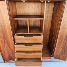 an open wooden cabinet with drawers on the bottom and shelves in the top, side by side