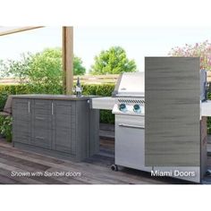 an outdoor kitchen with grill, sink and bbq in the middle of a deck