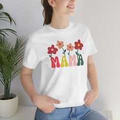 This Groovy Mama T-shirt, featuring a retro floral design is the perfect gift for Mothers. Made of soft, lightweight cotton, this shirt has a standard fit and runs true to size. The shirt is pre-shrunk, but it may shrink slightly with washing. The shirt is available in XS through 3XL sizes, with measurements listed in the sizing chart. Women may want to order a size down for a more fitted look. Please refer to the size chart for the best fit. 100% Airlume combed and ringspun cotton (fiber content may vary for different colors) *Print colors - Actual colors may vary from our listing photo and the final product. We cannot guarantee the color you see on your monitor because of different monitor resolution. The shirt is usually printed after the order is placed, with a turnaround time of 48 ho Retro Cotton T-shirt For Spring, Retro Short Sleeve T-shirt With Floral Print, Trendy Cotton T-shirt With Retro Print, Relaxed Fit Cotton Shirt With Multicolor Print, Relaxed Fit Multicolor Print Cotton Shirt, Relaxed Fit Multicolor Cotton Shirt, Casual Relaxed Fit T-shirt With Retro Print, Mother's Day Floral Print Crew Neck T-shirt, Spring Custom Print Tops