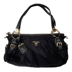 Prada Vintage - Nylon Satchel Bag Black  Good Conditions : 8/10 Made In Italy GHW This satchel features a nylon body with leather trim, rolled leather handles with belt details, a top zip closure, and interior zip and slip pockets. Measurements : Width : 14.5 inches Height : 9 inches Depth : 6.5 inches Hand Drop : 9 inches  Strap adjust  PLEASE CHECK ACTUAL SIZE CAREFULLY, NO RETURNS OR COMPLAIN FOR WRONG SIZE ACTUAL  *Shipping using Express Mail Service "will take 4 - 7 working day to arrived a Vintage Designer Shoulder Bags, Vintage Bags Designer, Luxury Nylon Bags With Gold-tone Hardware, Luxury Nylon Shoulder Bag With Leather Handles, Designer Nylon Bags With Leather Trim, Designer Nylon Bags With Leather Handles, Vintage Designer Bags Aesthetic, 80s Bags Vintage, Black Luxury Bag