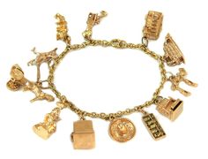 This beautiful landmark and travel theme bracelet is crafted from 18k yellow gold featuring 12 14k charms in 3D depicting boat, bus, entertainment figures like Minnie Mouse and slot machine and items and iconic landmark charms. The sturdy oval link chain secures with a round clasp and has the 14k gold content stamp. Material:  18k gold bracelet & 14k yellow gold charms Measurement:  7" long x 0.15" wide x 0.15" high Charms varies in size between 1.15" - 0.38" long x 0.85"-0.60" tall. Weight:  45 Luxury Yellow Gold Vintage Charm Bracelet, Luxury Yellow Gold Collectible Charm Bracelet, Luxury Gold Bracelets With Vintage Charm, Gold Charm Bracelet As A Souvenir, 18k Gold Bracelet, Travel Theme, Gold Charms, Travel Themes, Slot Machine