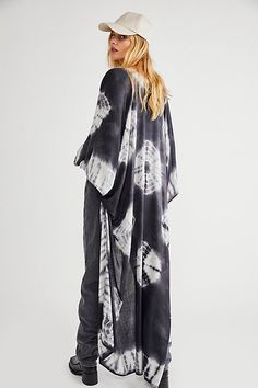 In a super soft fabric and tie dye pattern this oversized maxi kimono features statement cutout detailing under the arms. Chic Flowy Kimono For Beach Cover-up, Unlined Bohemian Maxi Dress, Flowy Maxi Dress With Kimono Sleeves, Bohemian Flowy Unlined Cover-up, Oversized Black Bohemian Cover-up, Flowy Bohemian Unlined Cover-up, Flowy Long Breezy Cover-up, Chic Flowy Cover-up For Festivals, Flowy Unlined Beachwear Cover-up