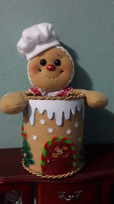 a teddy bear dressed in a chef's outfit sitting on top of a wooden table