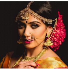 a woman in a bridal outfit with her hands on her head