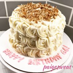 a birthday cake with white frosting and toppings