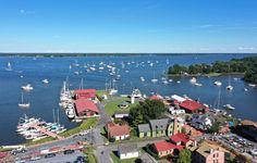 an aerial view of a harbor with boats in the water and houses on land around it