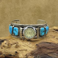 Beautiful Navajo watch cuff is made from sterling silver and has 5 turquoise stones on each side. There are tiny sterling silver beads between each turquoise stone. The inside measures 5 7/8" not including the gap.  The gap measures 1 1/4".  It weighs 60.7 grams. The inside is stamped "MT" and "sterling".  We believe this to be the work of Navajo artist Melvin Thompson. Please let me know if you have any questions.   BT-2 Christian Bracelets, Golden Hill, Cuff Watch, Turquoise Stones, Tucson Az, The Gap, Sterling Silver Bead, Silver Turquoise, Turquoise Sterling Silver