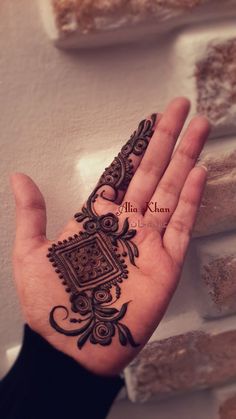 a person's hand with a henna on it