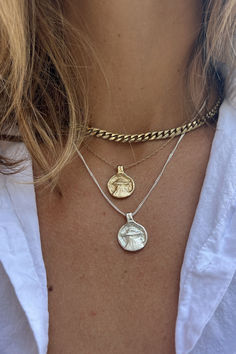 A double-sided UFO necklace in silver or gold. The backside of the necklace is inscribed with "GOIN HOME". Silver Figaro Chain Jewelry With Round Pendant, Silver Jewelry With Figaro Chain And Round Pendant, Silver Tarnish-resistant Brass Coin Necklace, Gold Medallion Hand Cast Jewelry, Gold Medallion Jewelry Hand Cast, Silver Engraved Brass Chain Necklace, Silver Figaro Chain Medallion Jewelry, Silver Medallion Figaro Chain Jewelry, Silver Medallion With Figaro Chain