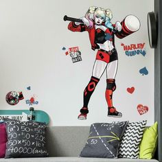 a living room with a couch and wall decals on the walls, including a harley girl holding a baseball bat