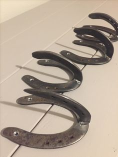 four pairs of scissors sitting on top of a white table next to each other with holes in them