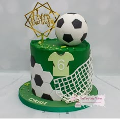 a birthday cake with soccer themed decorations