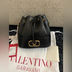 Valentino Garavani Vlogo Signature Mini Bucket Bag In Nappa Leather With Chain Antique Brass-Finish Logo And Hardware - Drawstring Closure And Chain Strap - Chain Drop: 54 Cm / 21.2 In. - Dimensions: W20xh17xd8.5 Cm / W7.8xh6.6xd3.3 In. - Made In Italy Valentino Garavani Bag, Mini Bucket Bag, Mini Bucket Bags, Mini Bucket, Nappa Leather, Brass Finish, Valentino Garavani, Chain Strap, Antique Brass