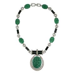 David Webb inspired large necklace by Joseph Mazer, NY from the 1970's. Bars of black glass and jade Czech glass ovals are used between the pave links to join the necklace with a large central carved faux jade and pave hoop pendant. Mazer represented the finest quality in faux jewelry and mimicked the designer fine jewelry of the day. Signed "Jomaz". 18.5" x 5/8", Pendant 3" x 1.75". 1970's USA. Excellent condition. Necklaces Green, Green Pendant, David Webb, Onyx Pendant, Carved Jade, Large Necklace, Pendants Necklaces, Green Oval, Jewelry Pendants