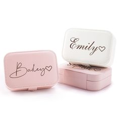 two small pink and white boxes with writing on the front, one has a name in it