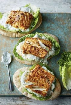 chicken and lettuce on pita breads with ranch dressing in the middle