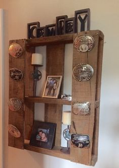 a wooden shelf with pictures and other items on it