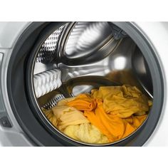 an open washing machine with clothes in it