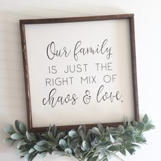 a framed sign that says our family is just the right mix of chaos and love