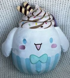 a stuffed animal with ice cream in it's mouth on a white chair cushion