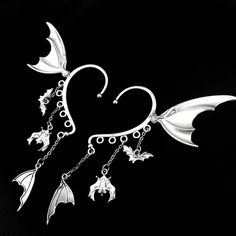 Bat wing ear cuff Pair Beautiful bat themed ear wrap, with tiny hanging bats and wings. Fits perfectly on most ear types and great for vampire cosplays, fantasy photoshoots, gothic vibes, festivals and more. Handmade to order, ready in 1 week Gothic Single Cartilage Earring For Party, Gothic Single Earring Ear Cuff For Party, Gothic Single Ear Cuff For Party, Fantasy Metal Ear Cuff For Party, Gothic Style Ear Cuff As Gift, Halloween Cosplay Earrings, Silver Gothic Ear Cuff For Party, Gothic Horned Jewelry For Halloween, Bat Wing Ear Cuff