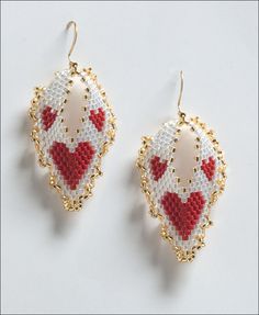 two pairs of red and white beaded earrings with hearts on them, sitting next to each other