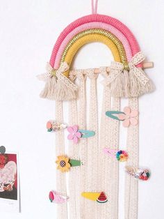 a wall hanging made out of macrame beads and other things on the wall