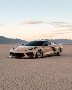 a gold sports car parked in the desert