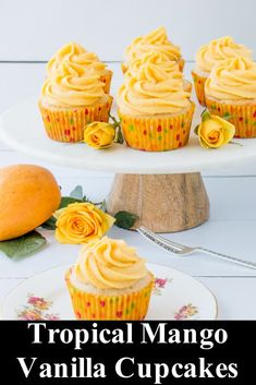 tropical mango vanilla cupcakes with orange frosting on a white cake platter