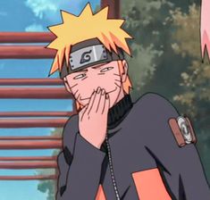 naruto is holding his hands to his face