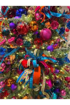 a colorful christmas tree with ribbons and ornaments