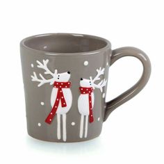 a coffee cup with two reindeers on it