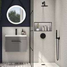 a bathroom with a sink, mirror and shower stall in the corner next to it