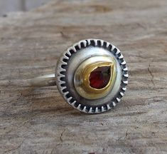 Garnet Ring - One of a kind Garnet ring - the stone set in 24k solid gold on top round sterling silver band 1.5mm wide in Matte finish. The Garnet rose Cut drop stone size is 4/7mm The ring size is 8US or 57Uk. The Ring will be packed in lovely a gift box and will be ready to be given as a gift or kept for yourself. Free Shipping Your item will be shipped via registered air mail with tracking number. Please contact me with any questions or requests. my Sterling Silver Hidden Seeds Collection at Unique Gemstone Dome Ring, Unique Dome Ring With Gemstone For Anniversary, Unique Hallmarked Round Topaz Ring, Unique Ruby Ring With Bezel Setting For Anniversary, Unique Round Ruby Ring With Stone Setting, Unique Sterling Silver Cluster Ring, Unique Round Bezel Set Birthstone Ring, Unique Topaz Ring With Stone Setting, Unique Rings With Round Stone For Anniversary