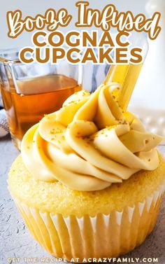 a cupcake with yellow frosting on top and the words booze infused cognac