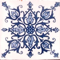 a blue and white snowflake is shown on a white background, it looks like an ornament