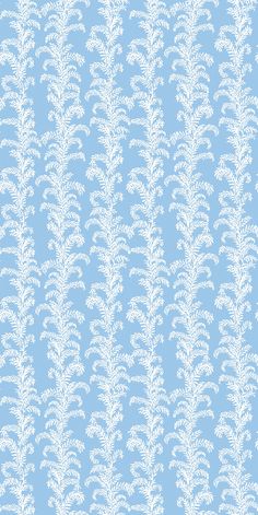 a blue background with white leaves on it